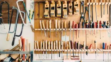 assorted handheld tools in tool rack